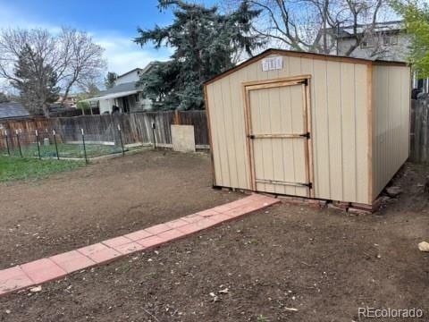 view of shed featuring fence