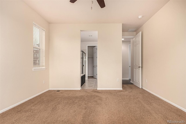 unfurnished bedroom with carpet floors, a ceiling fan, and baseboards