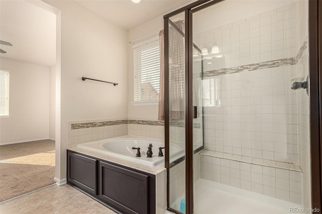 bathroom featuring a shower stall, baseboards, a bath, and tile patterned floors