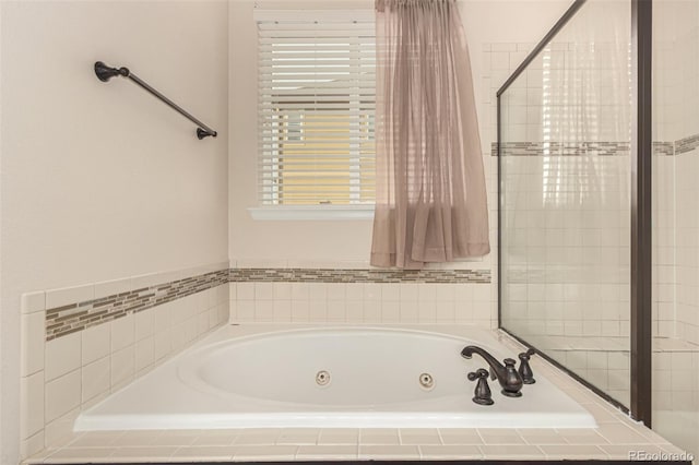 bathroom featuring a tub with jets