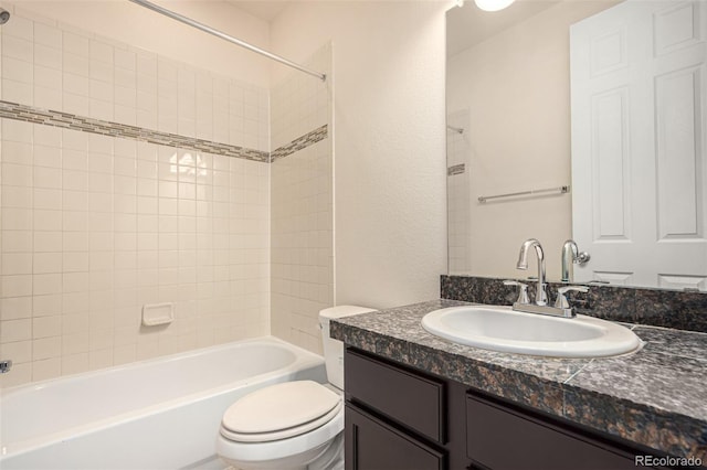 bathroom with bathtub / shower combination, vanity, and toilet