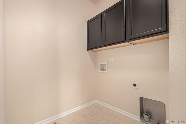 clothes washing area featuring cabinet space, baseboards, hookup for an electric dryer, light floors, and washer hookup