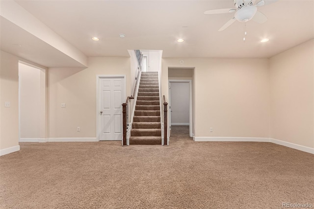 finished basement with light carpet, stairs, baseboards, and recessed lighting