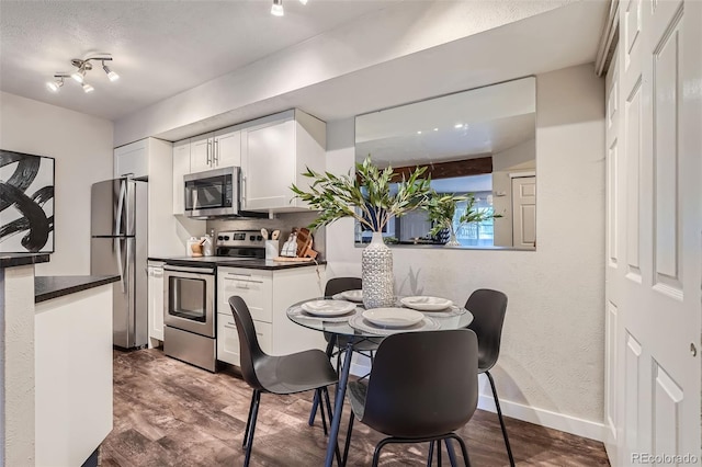 dining space with dark wood-type flooring