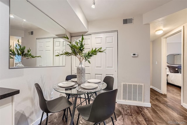 dining space featuring dark wood-type flooring