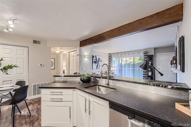 kitchen with white cabinets, dark hardwood / wood-style flooring, a textured ceiling, beamed ceiling, and sink