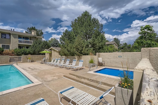 view of swimming pool featuring a patio area