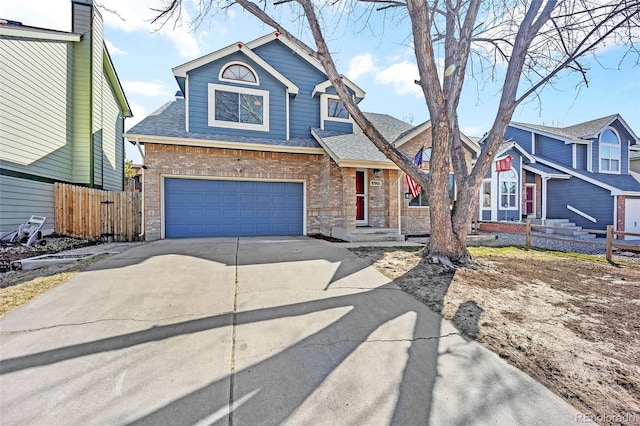 view of front of house with brick siding, a shingled roof, fence, concrete driveway, and an attached garage