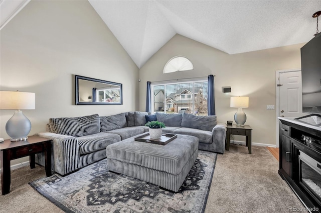 living room with high vaulted ceiling, light colored carpet, baseboards, and a textured ceiling