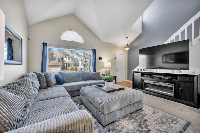 living room with high vaulted ceiling