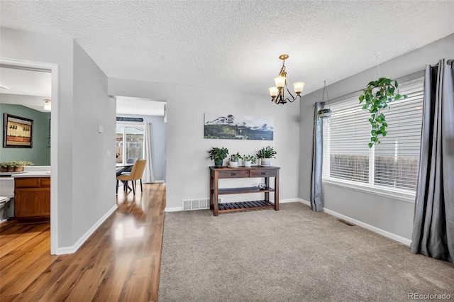 dining area featuring a wealth of natural light, visible vents, baseboards, and a chandelier