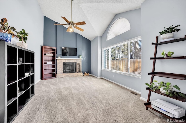 unfurnished living room with visible vents, a ceiling fan, a textured ceiling, carpet floors, and a fireplace