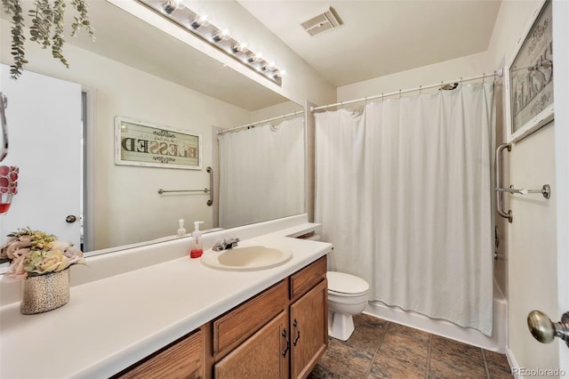 bathroom featuring vanity, visible vents, shower / bath combination with curtain, stone finish floor, and toilet