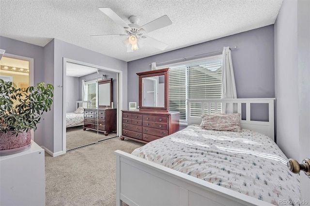 bedroom featuring a closet, ceiling fan, a textured ceiling, and carpet