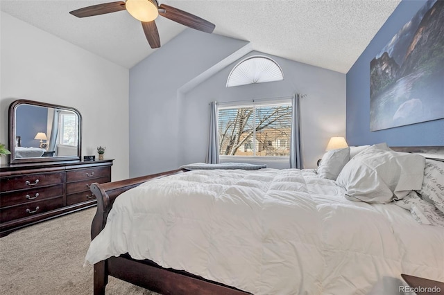 carpeted bedroom with a textured ceiling, a ceiling fan, and vaulted ceiling