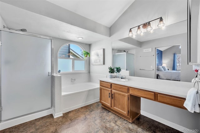 ensuite bathroom with a garden tub, a stall shower, ensuite bath, lofted ceiling, and vanity