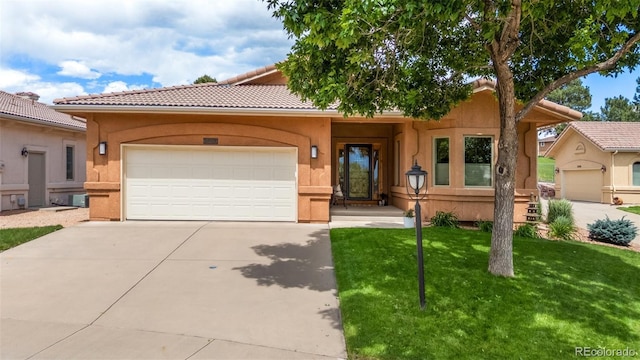 2467 Spanish Oak Ter, Colorado Springs, CO 80920 - view of front of house with driveway, an attached garage, a front lawn, stucco siding, and a tiled roof