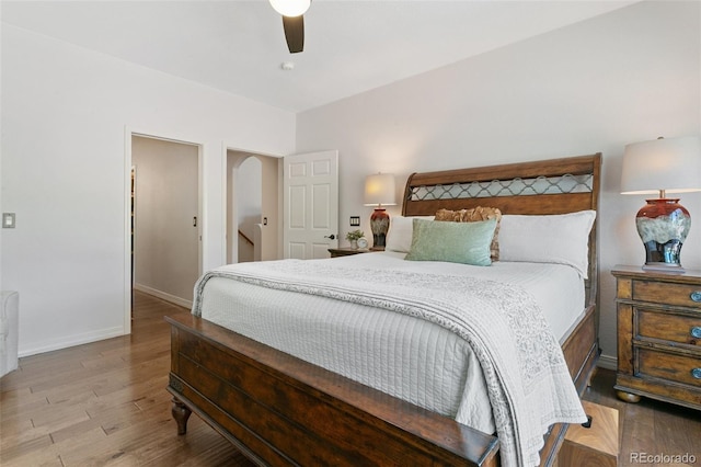 2467 Spanish Oak Ter, Colorado Springs, CO 80920 - bedroom featuring wood finished floors, arched walkways, and a ceiling fan
