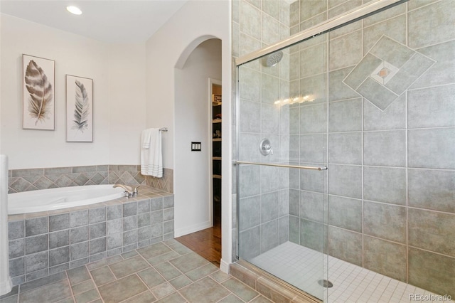 2467 Spanish Oak Ter, Colorado Springs, CO 80920 - full bath with a garden tub, a shower stall, a walk in closet, recessed lighting, and tile patterned floors