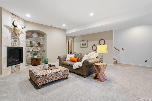 2467 Spanish Oak Ter, Colorado Springs, CO 80920 - living area with carpet, recessed lighting, arched walkways, stairway, and a tiled fireplace