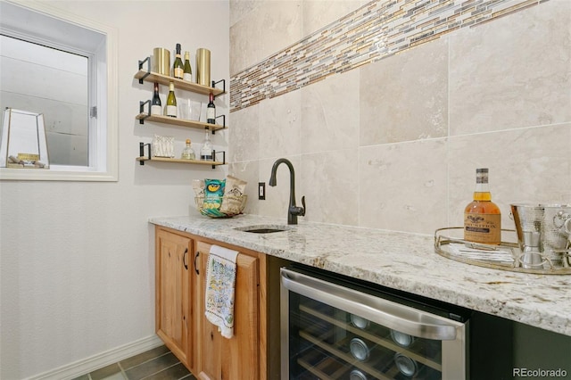 2467 Spanish Oak Ter, Colorado Springs, CO 80920 - indoor wet bar featuring beverage cooler and backsplash