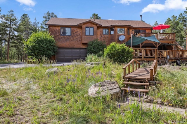 10668 Crystal Way, Morrison, CO 80465 - rear view of house featuring a deck and a garage