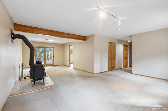 10668 Crystal Way, Morrison, CO 80465 - unfurnished living room with a wood stove, light carpet, track lighting, and beamed ceiling
