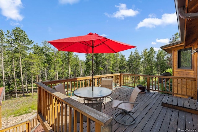 10668 Crystal Way, Morrison, CO 80465 - wooden terrace featuring outdoor dining space and a forest view