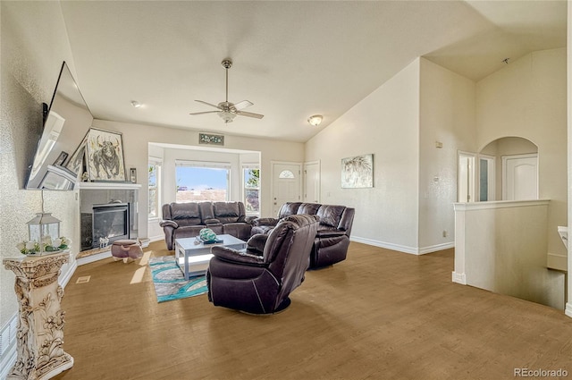 living room featuring ceiling fan, hardwood / wood-style floors, and lofted ceiling