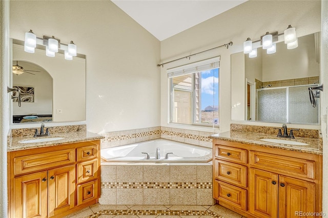 bathroom featuring vanity, ceiling fan, shower with separate bathtub, and vaulted ceiling