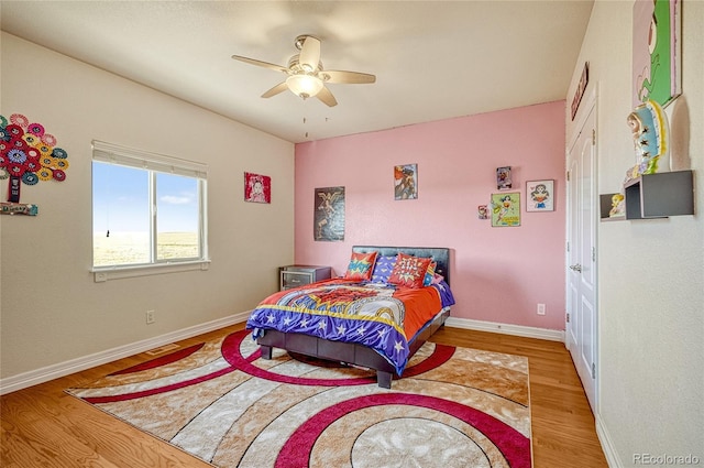 bedroom with light hardwood / wood-style flooring and ceiling fan