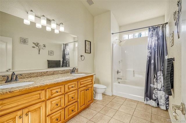 full bathroom with vanity, toilet, shower / bath combo with shower curtain, and tile patterned flooring