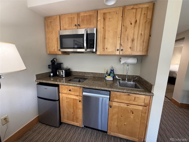 6 Emmons Rd Unit 379/381, Mount Crested Butte, CO 81225 - kitchen featuring appliances with stainless steel finishes, dark colored carpet, and dark stone countertops