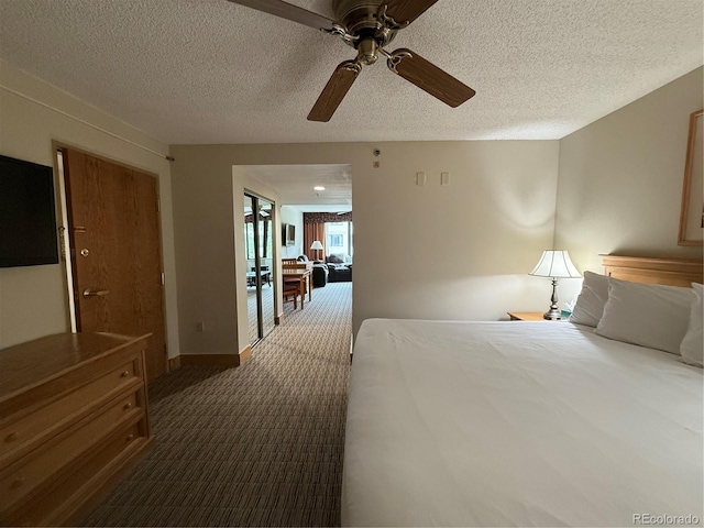 6 Emmons Rd Unit 379/381, Mount Crested Butte, CO 81225 - bedroom with dark carpet, a textured ceiling, and ceiling fan