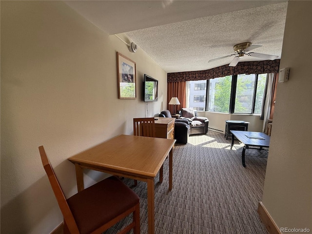 6 Emmons Rd Unit 379/381, Mount Crested Butte, CO 81225 - dining area with a textured ceiling, a baseboard radiator, dark carpet, and a ceiling fan