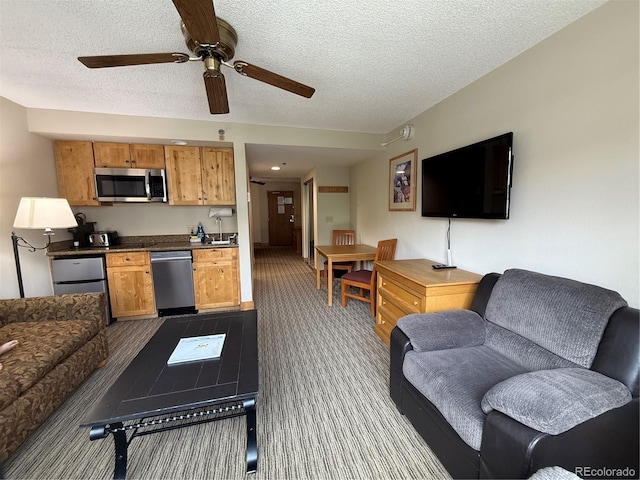 6 Emmons Rd Unit 379/381, Mount Crested Butte, CO 81225 - living room featuring dark colored carpet, ceiling fan, and a textured ceiling