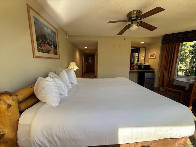 6 Emmons Rd Unit 379/381, Mount Crested Butte, CO 81225 - bedroom with freestanding refrigerator, a textured ceiling, and a ceiling fan
