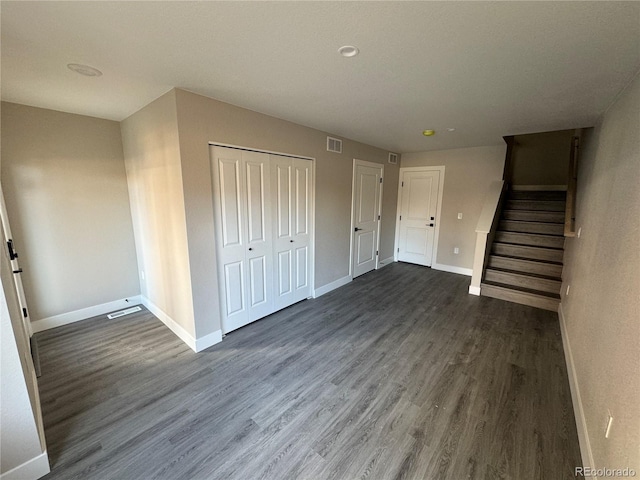 1652 N Lafayette St Unit 6, Denver, CO 80218 - unfurnished living room with dark wood-style floors and stairway