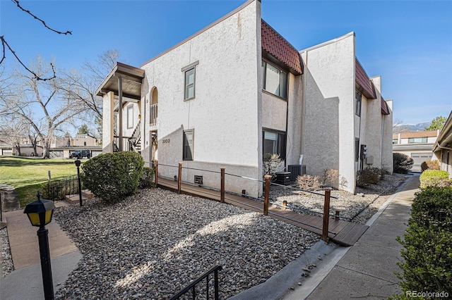 3103 Broadmoor Valley Rd Unit B, Colorado Springs, CO 80906 - view of home's exterior with a residential view, a tile roof, stucco siding, and crawl space