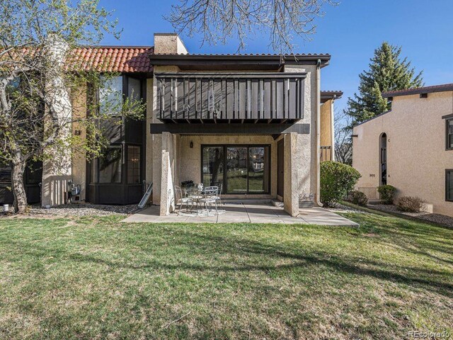 3103 Broadmoor Valley Rd Unit B, Colorado Springs, CO 80906 - rear view of house featuring a yard, stucco siding, a patio area, and a balcony