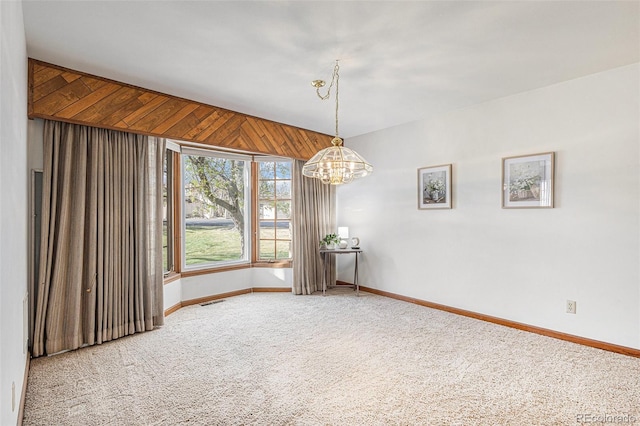 3103 Broadmoor Valley Rd Unit B, Colorado Springs, CO 80906 - carpeted empty room featuring a chandelier, baseboards, and visible vents