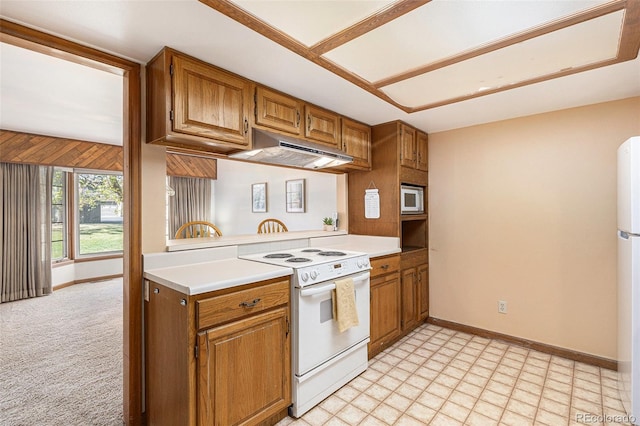 3103 Broadmoor Valley Rd Unit B, Colorado Springs, CO 80906 - kitchen featuring brown cabinetry, baseboards, white appliances, and under cabinet range hood