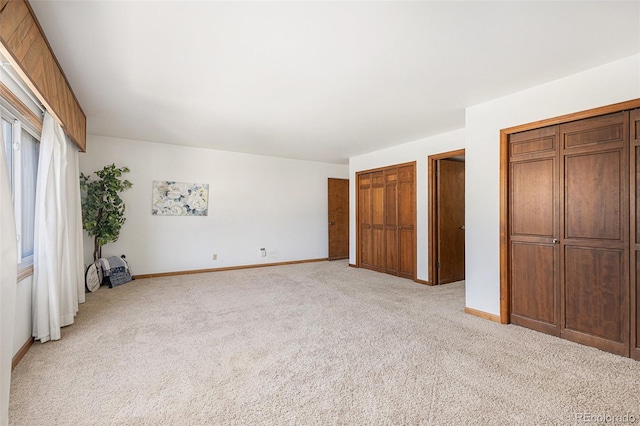 3103 Broadmoor Valley Rd Unit B, Colorado Springs, CO 80906 - unfurnished bedroom with baseboards, two closets, and light carpet