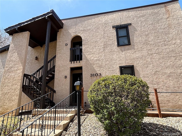3103 Broadmoor Valley Rd Unit B, Colorado Springs, CO 80906 - view of front of property featuring stairway, stucco siding, and fence