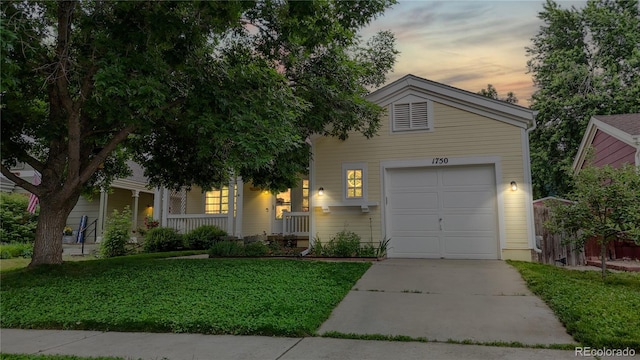 1750 Clark Dr, Erie, CO 80516 - view of front of home featuring driveway, a porch, a front yard, and a garage