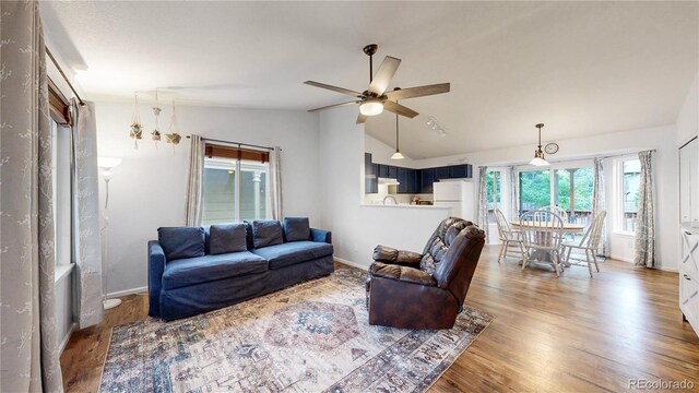 1750 Clark Dr, Erie, CO 80516 - living area with lofted ceiling, a ceiling fan, and wood finished floors