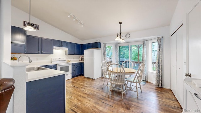 1750 Clark Dr, Erie, CO 80516 - kitchen with white appliances, under cabinet range hood, vaulted ceiling, blue cabinets, and light countertops