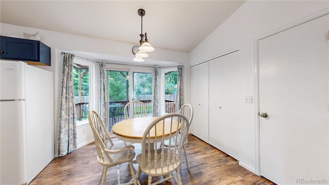 1750 Clark Dr, Erie, CO 80516 - dining area featuring light wood-style floors and vaulted ceiling