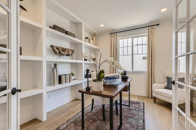 office featuring french doors and light hardwood / wood-style floors