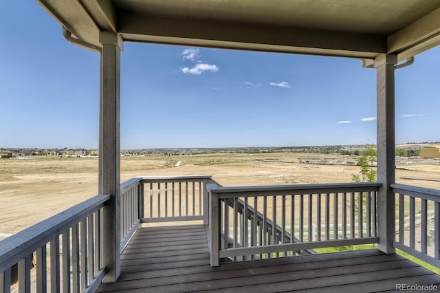 wooden terrace featuring a rural view